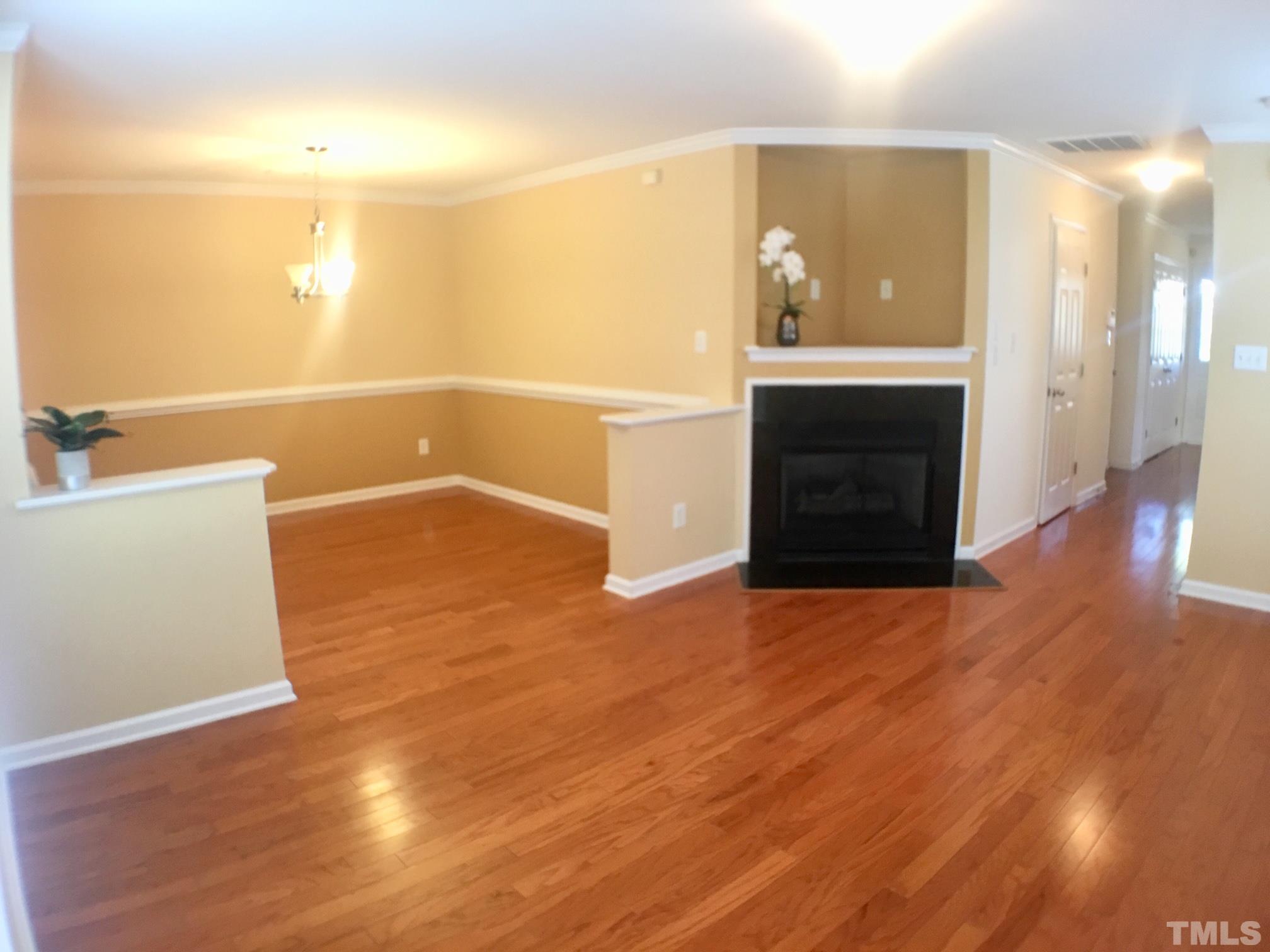 9801 Raleigh, NC 27617 - Photo 4 of 23 a view of a hallway with wooden floor