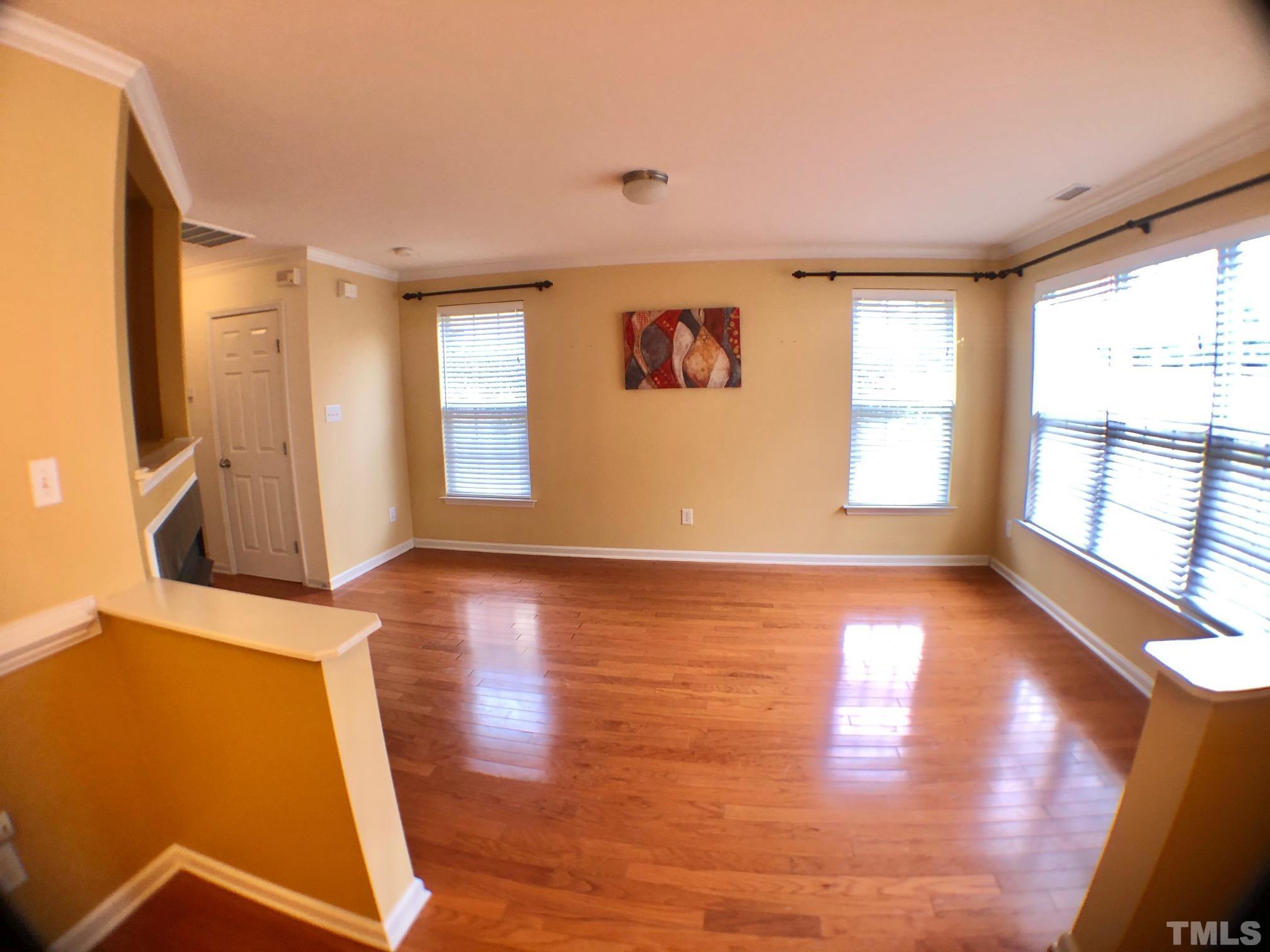9801 Raleigh, NC 27617 - Photo 6 of 23 a view of an empty room with wooden floor and a window