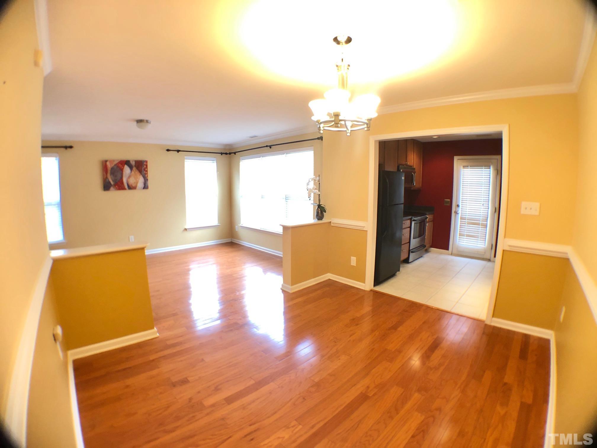 9801 Raleigh, NC 27617 - Photo 7 of 23 a view of a livingroom with wooden floor and a kitchen