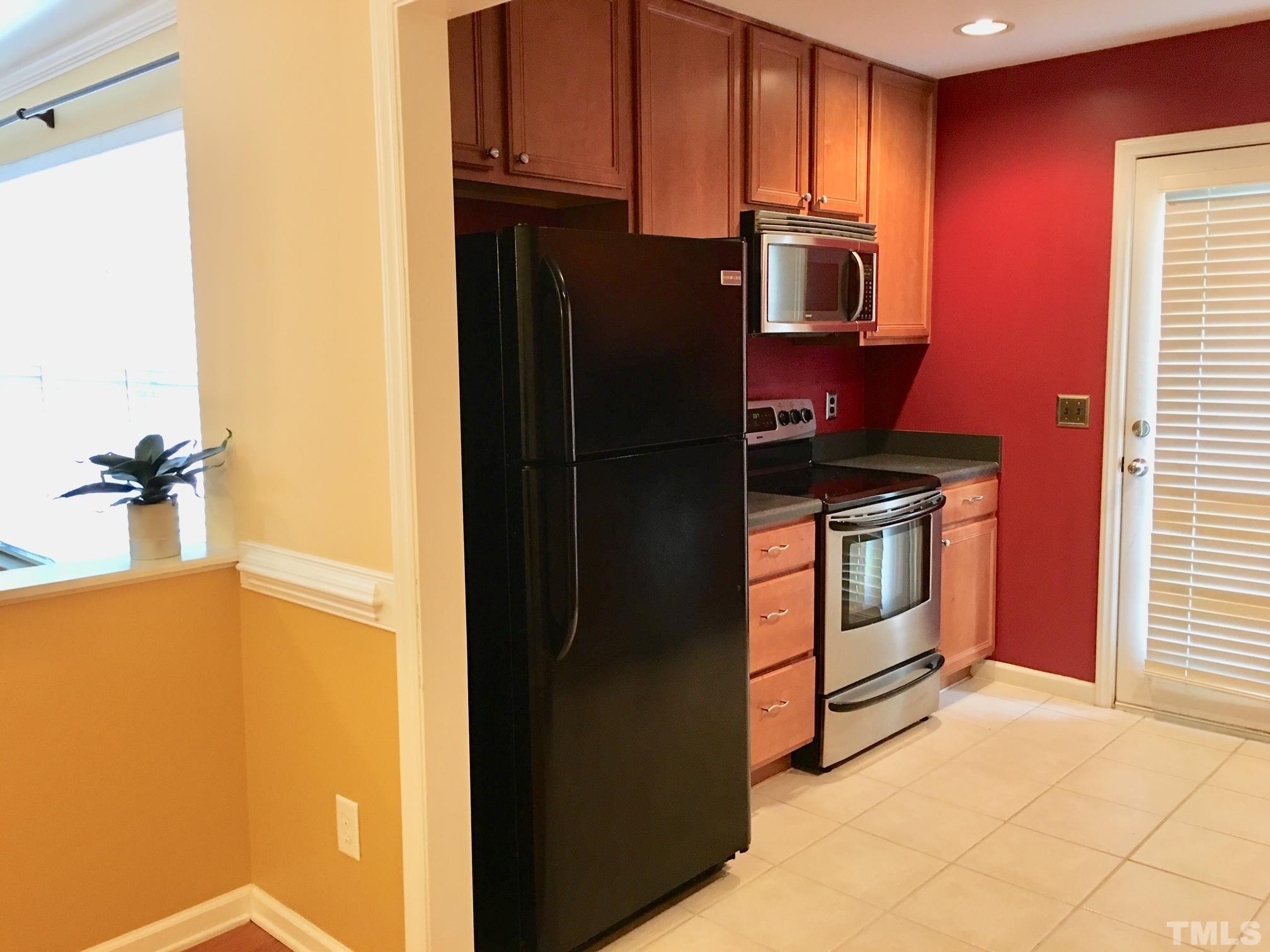 9801 Raleigh, NC 27617 - Photo 9 of 23 a kitchen with stainless steel appliances a refrigerator stove and microwave