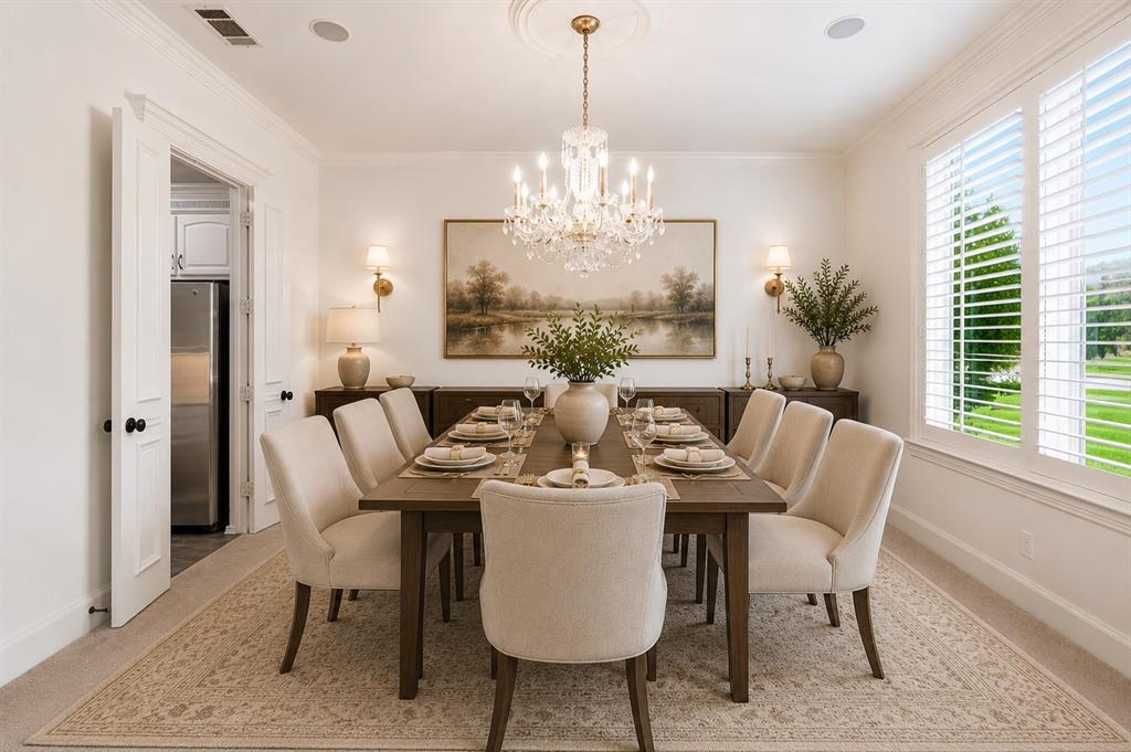 967 East Bethel School Road Coppell, TX 75019 - Photo 12 of 39 Dining room featuring a crystal chandelier, crown molding, and wall sconces