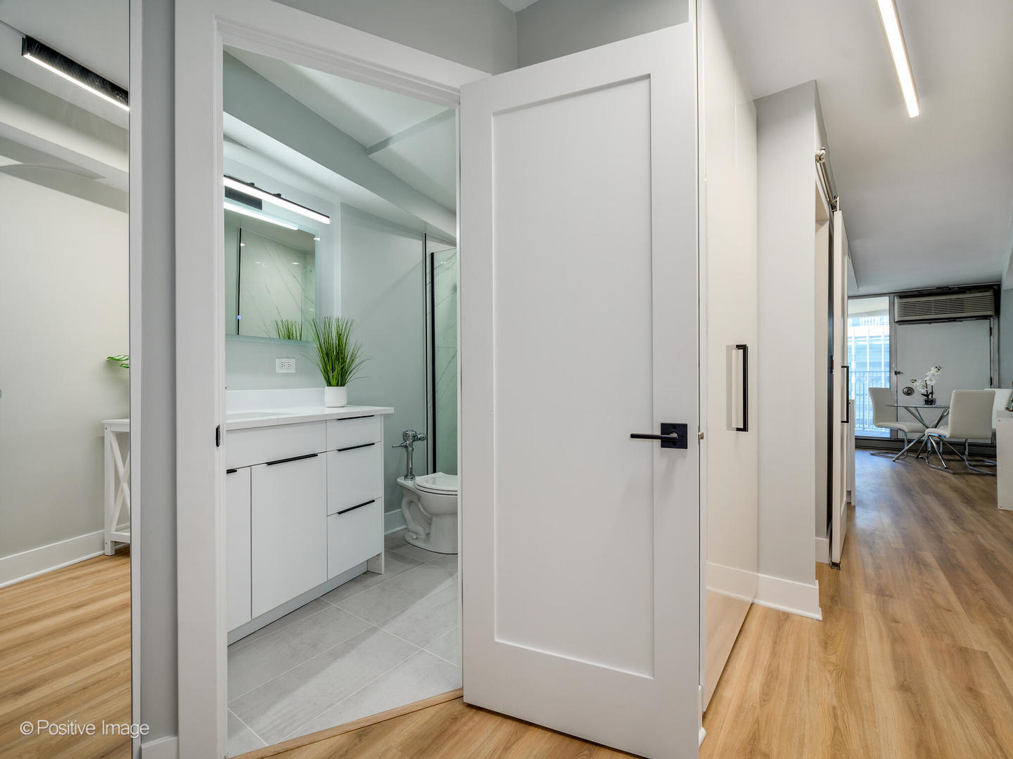 300 North State Street, Unit 5125 Chicago, IL 60654 - Photo 11 of 21 a bathroom with a sink and a mirror