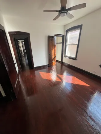 a view of a livingroom with wooden floor and window