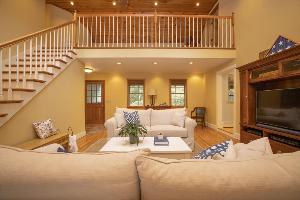 67 Chipaway Road Freetown, MA 02717 - Photo 16 of 32 a living room with furniture wooden floor and a flat screen tv