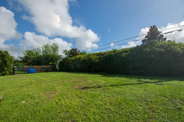 a view of a field of grass and basketball court