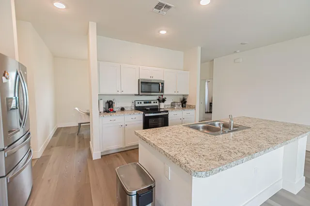 a kitchen with a sink stove and refrigerator