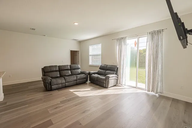a living room with furniture and a large window