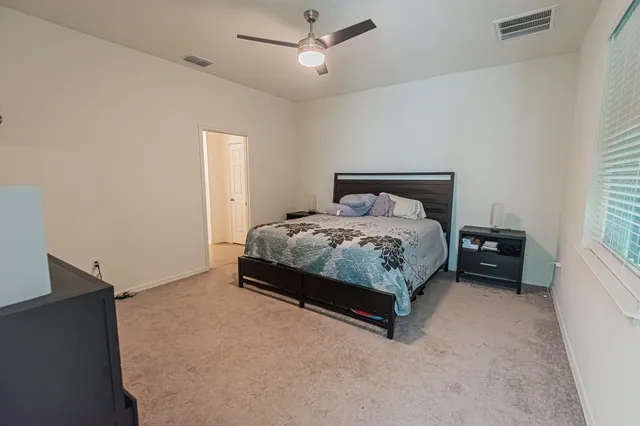 a bedroom with a bed and a window