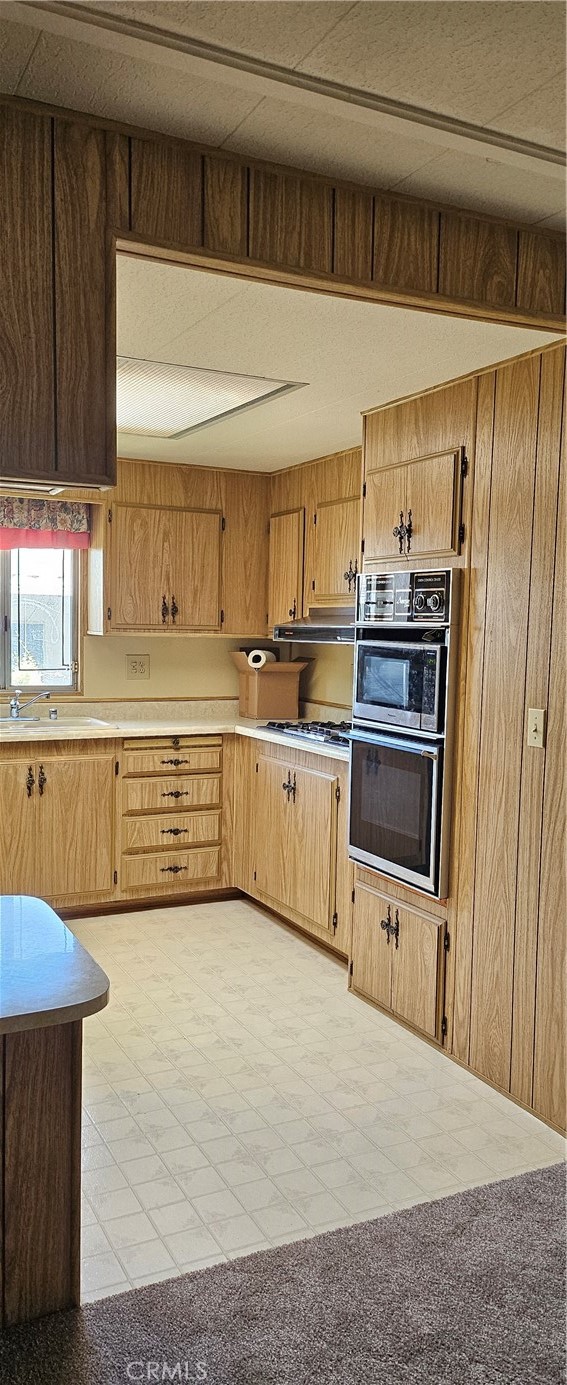 3500 Buchanan Street, Unit 128 Riverside, CA 92503 - Photo 19 of 19 a kitchen with stainless steel appliances a stove a sink and a refrigerator