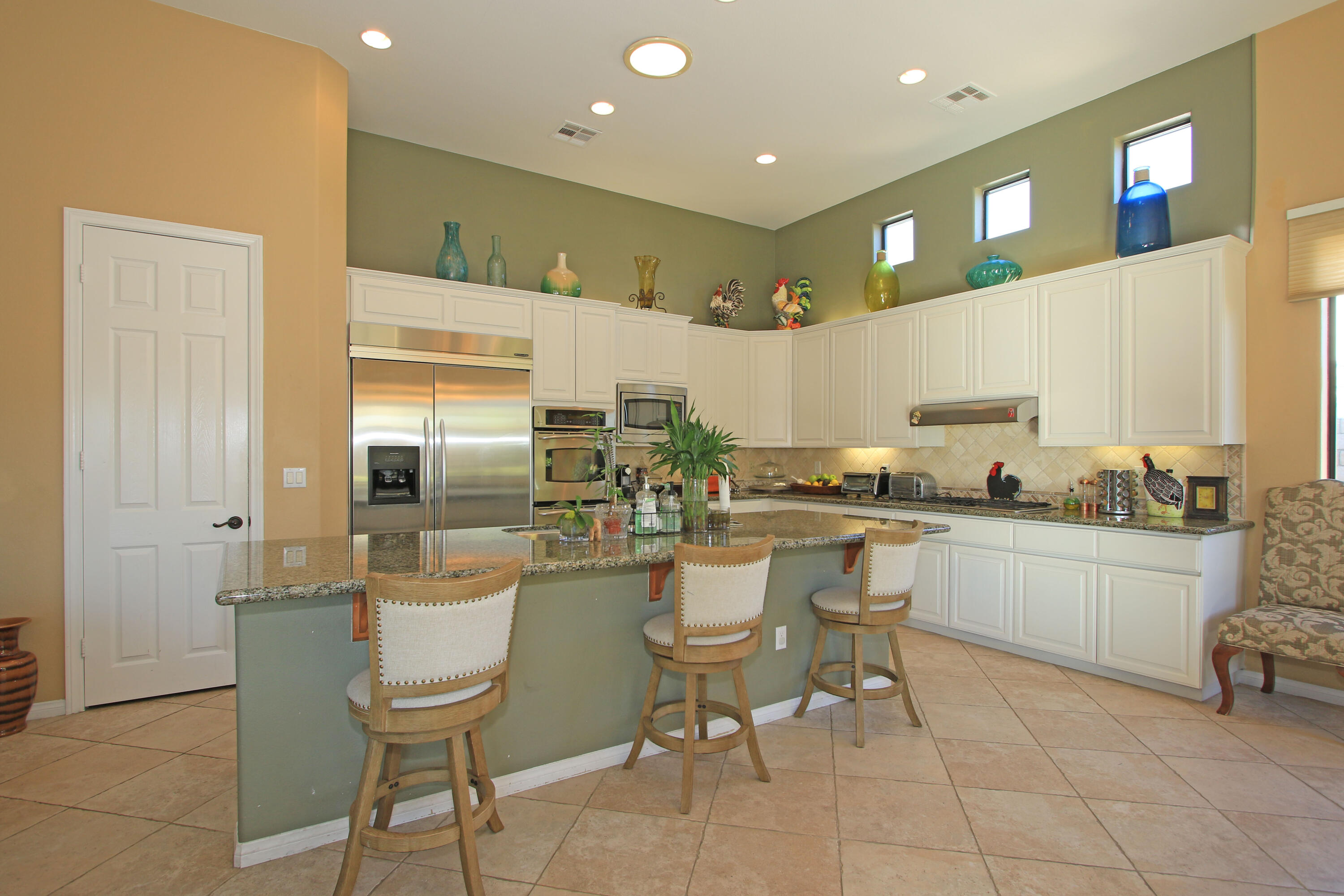 57576 Santa Rosa Trail La Quinta, CA 92253 - Photo 17 of 54 a kitchen with a sink and chairs