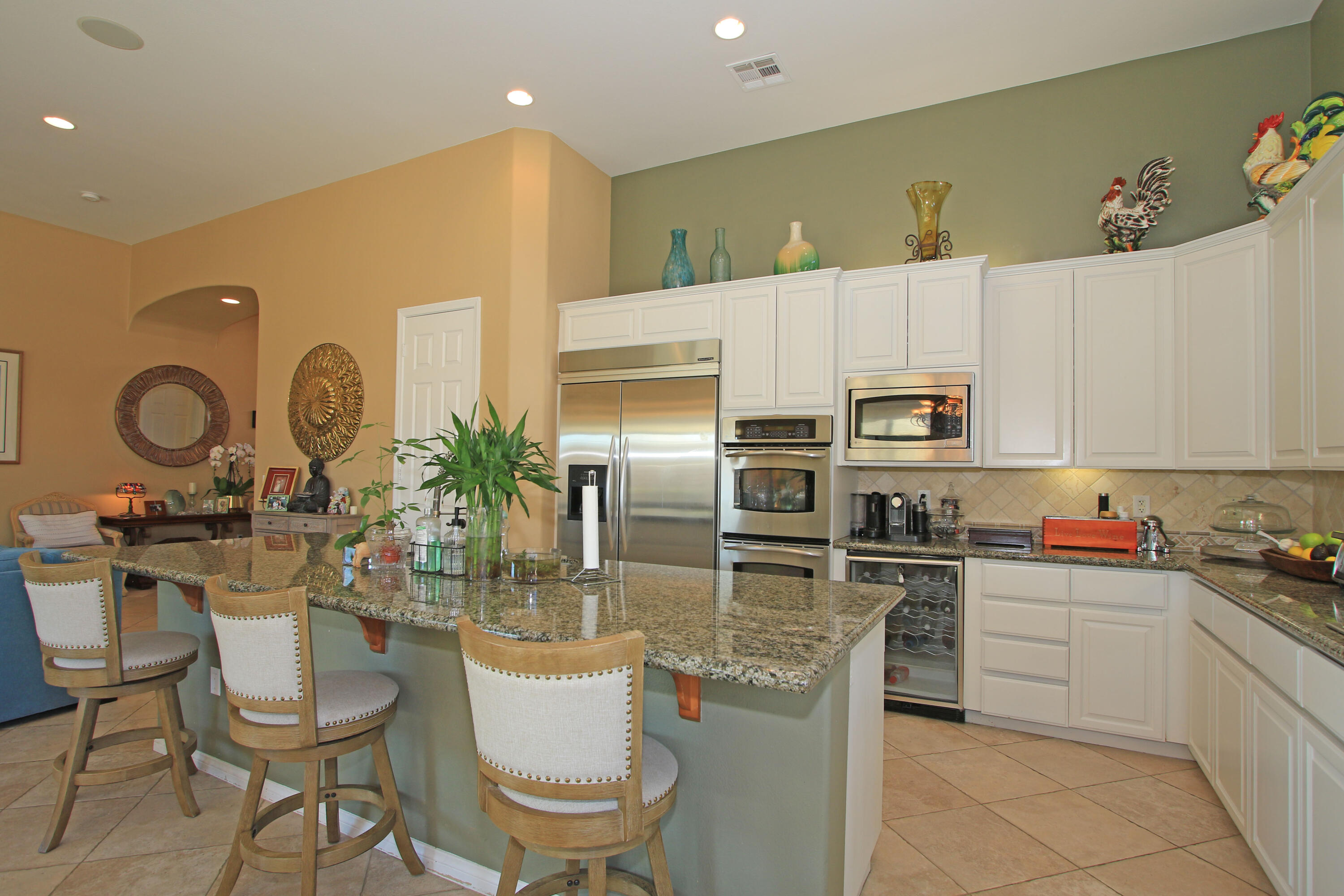 57576 Santa Rosa Trail La Quinta, CA 92253 - Photo 18 of 54 a kitchen with white cabinets and stainless steel appliances