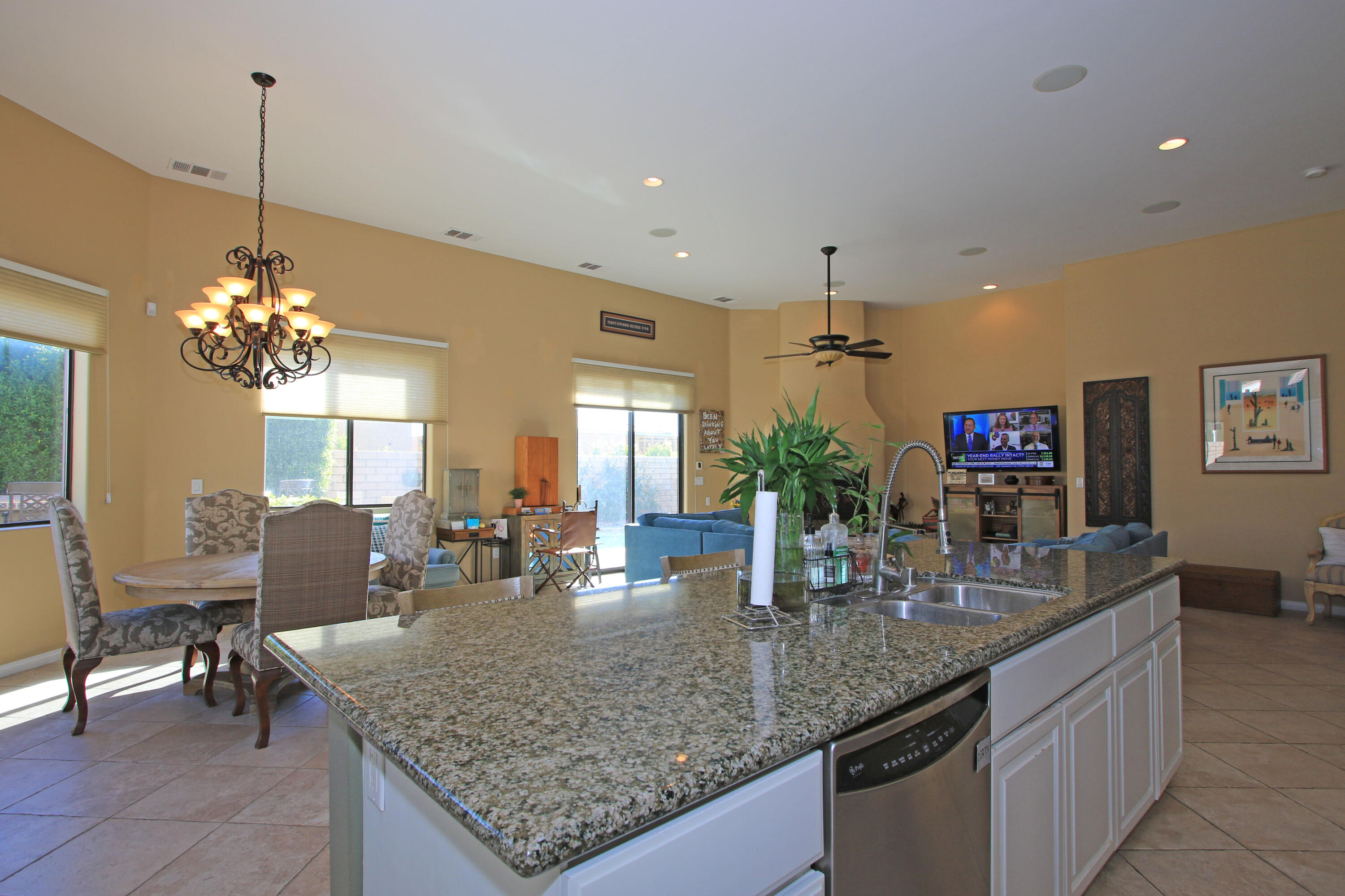 57576 Santa Rosa Trail La Quinta, CA 92253 - Photo 19 of 54 a kitchen with center island table and chairs in it