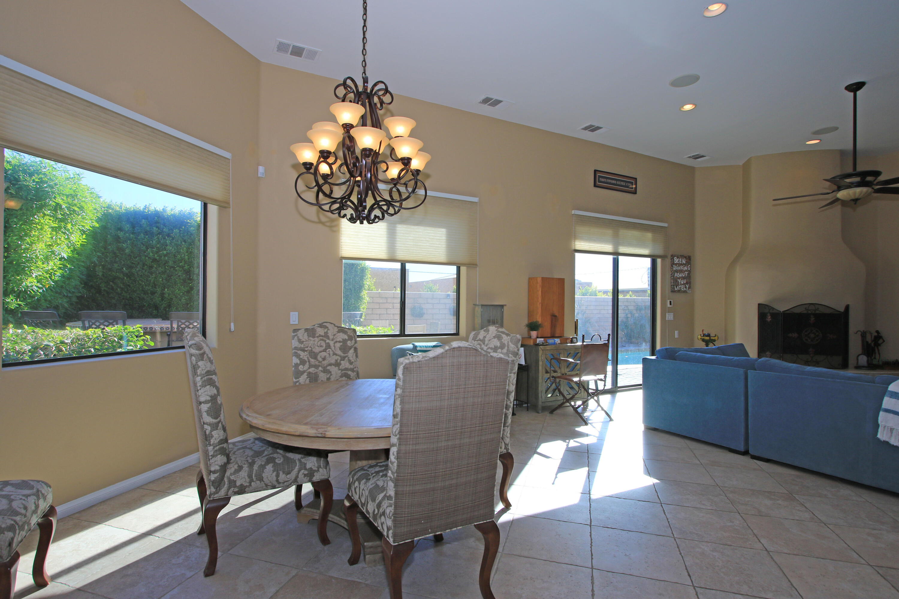 57576 Santa Rosa Trail La Quinta, CA 92253 - Photo 22 of 54 a dining room with furniture a chandelier and window