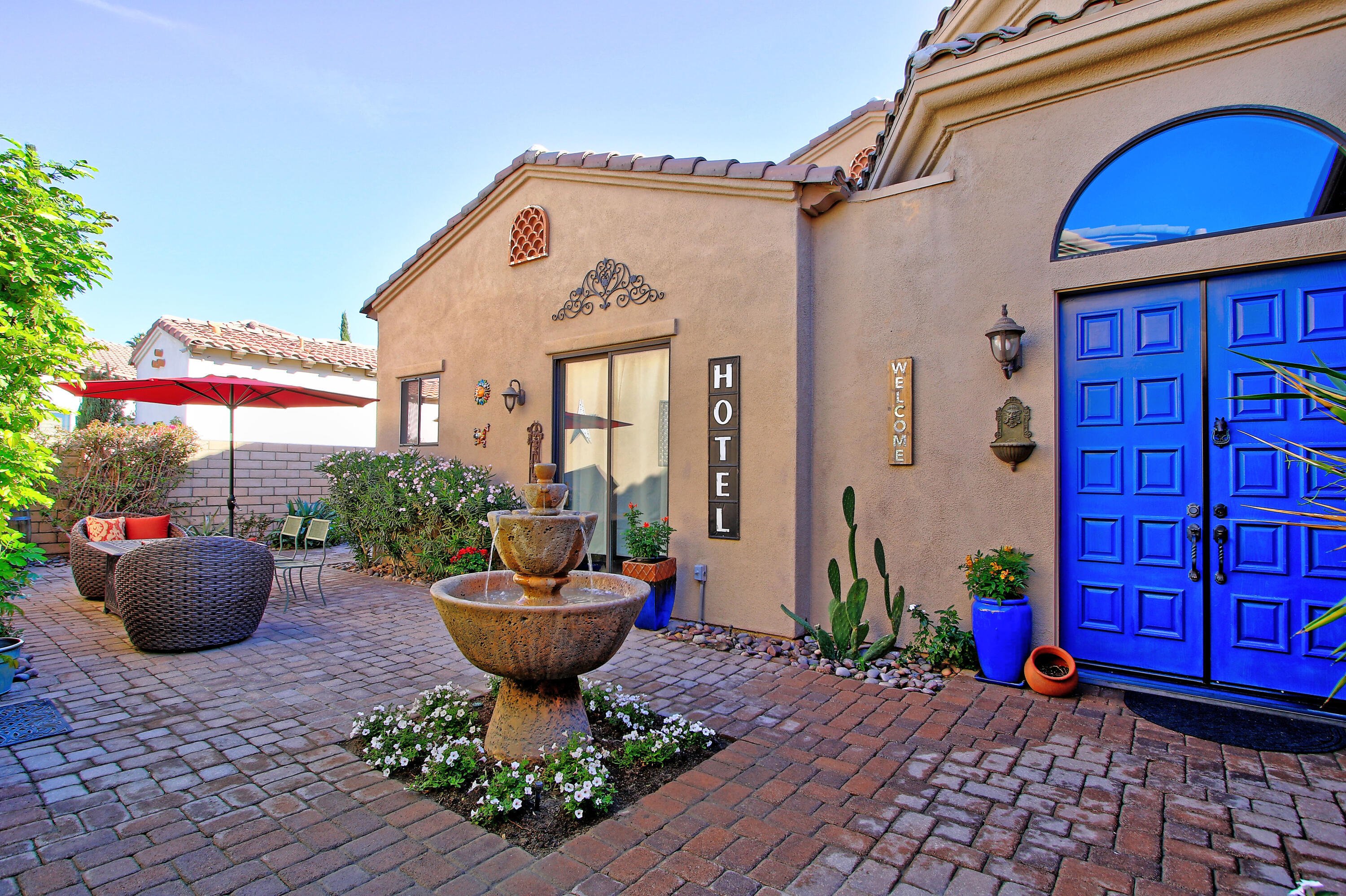 57576 Santa Rosa Trail La Quinta, CA 92253 - Photo 3 of 54 a view of a patio with couches chairs and potted plants