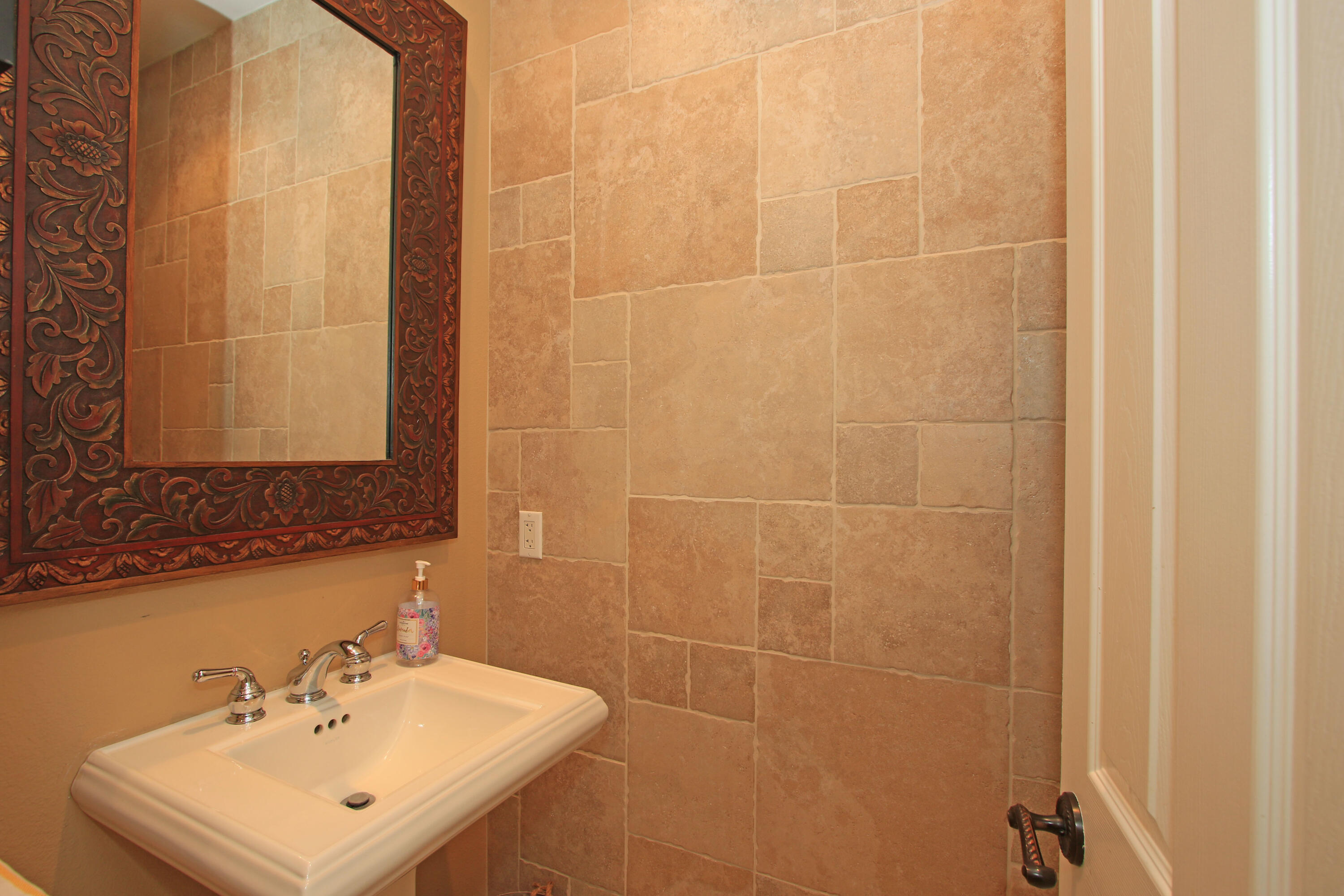 57576 Santa Rosa Trail La Quinta, CA 92253 - Photo 41 of 54 a bathroom with a sink a mirror and a shower