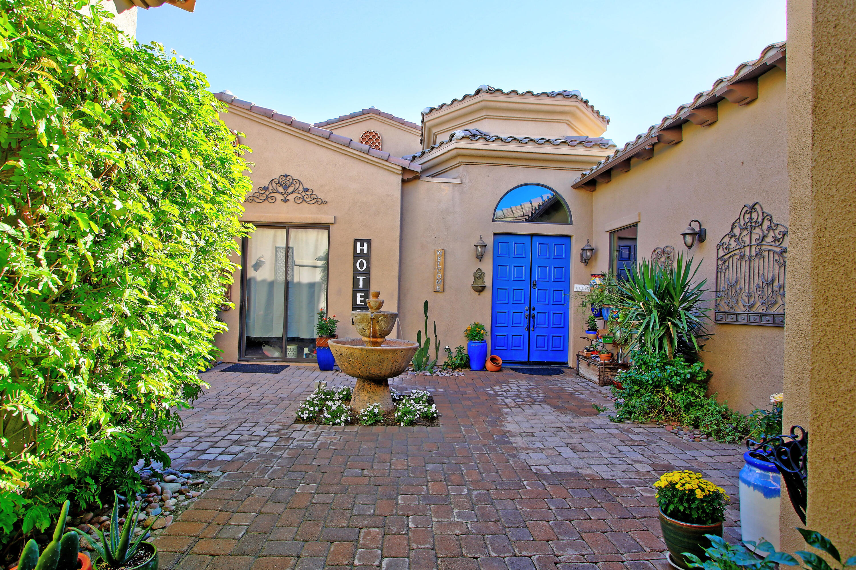 57576 Santa Rosa Trail La Quinta, CA 92253 - Photo 50 of 54 a view of a brick house with potted plants next to a road