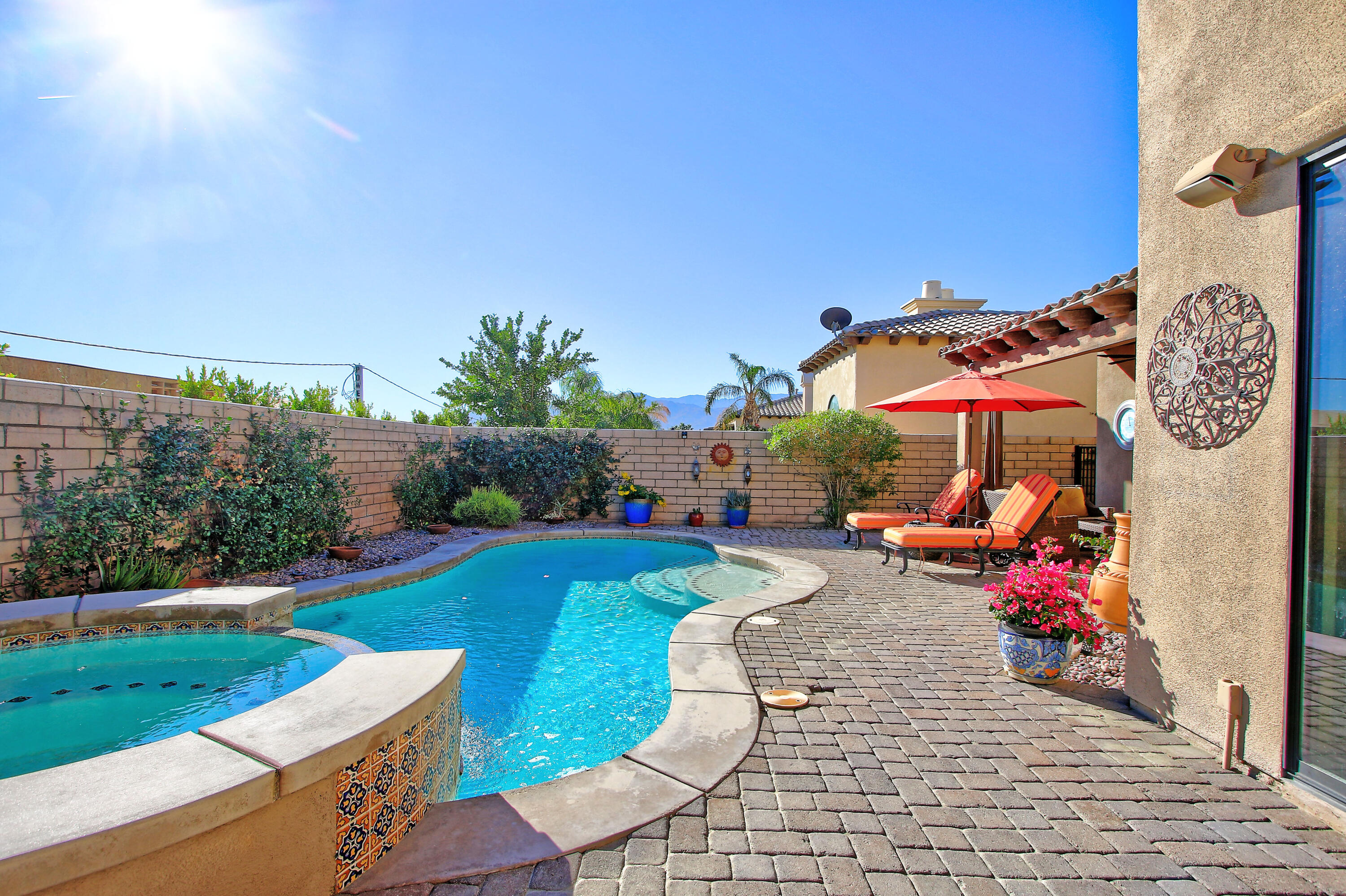 57576 Santa Rosa Trail La Quinta, CA 92253 - Photo 5 of 54 a view of a patio with table and chairs under an umbrella