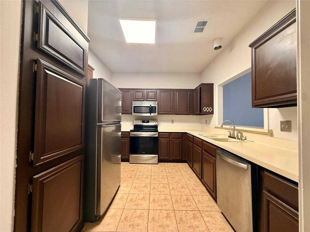 14277 Preston Road, Unit 512 Dallas, TX 75254 - Photo 1 of 8 a large kitchen with a large counter top stainless steel appliances and cabinets