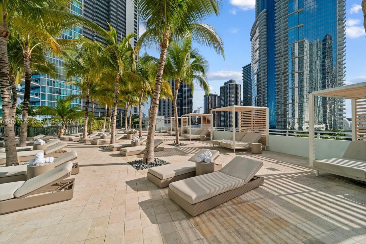 900 Biscayne Boulevard, Unit 4205 Miami, FL 33132 - Photo 15 of 35 a view of a swimming pool with lounge chairs