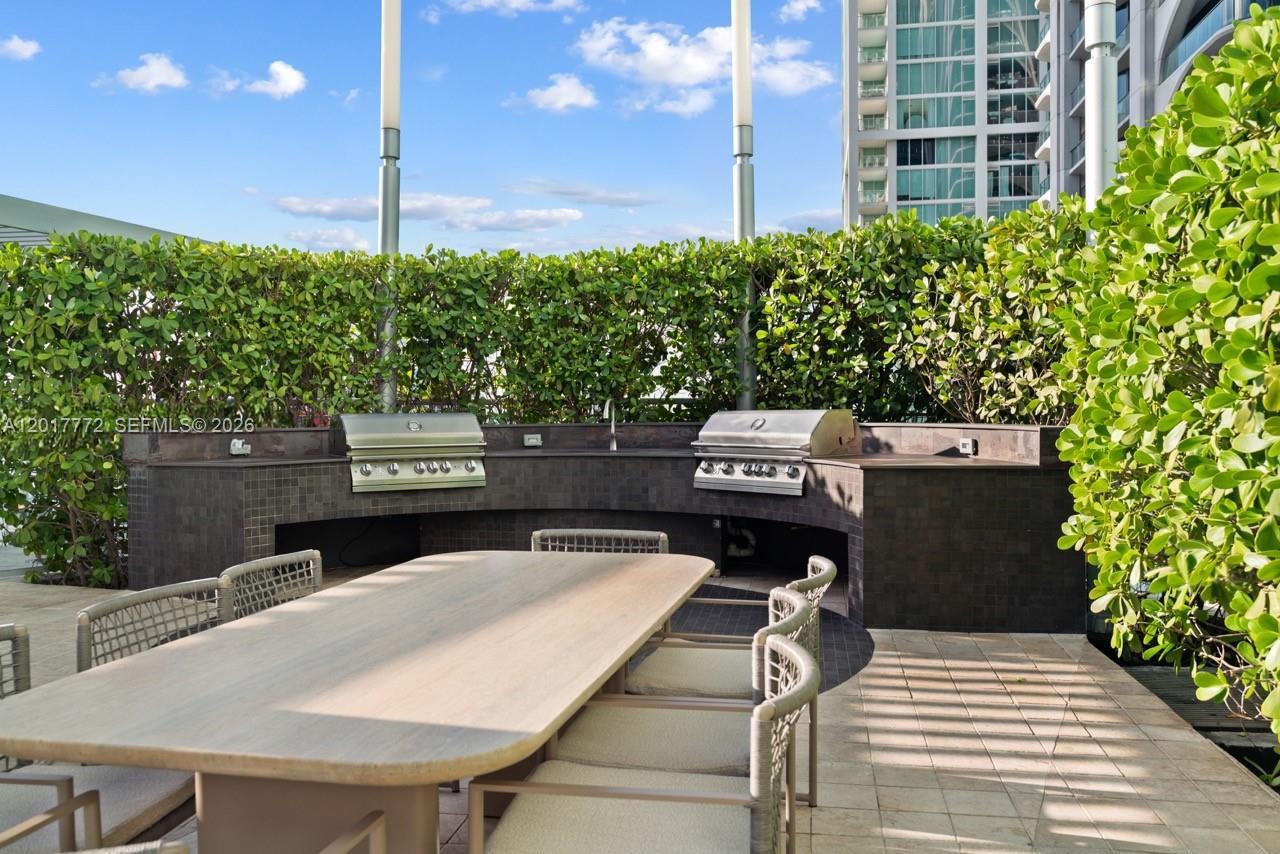 900 Biscayne Boulevard, Unit 4205 Miami, FL 33132 - Photo 16 of 35 a view of a patio with table and chairs and potted plants