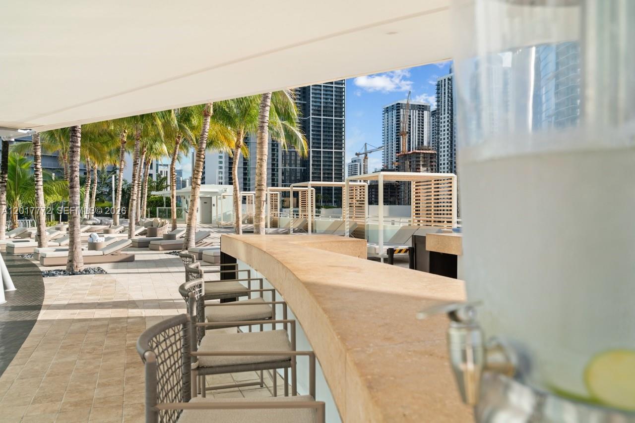 900 Biscayne Boulevard, Unit 4205 Miami, FL 33132 - Photo 30 of 35 a living room with furniture and a floor to ceiling window