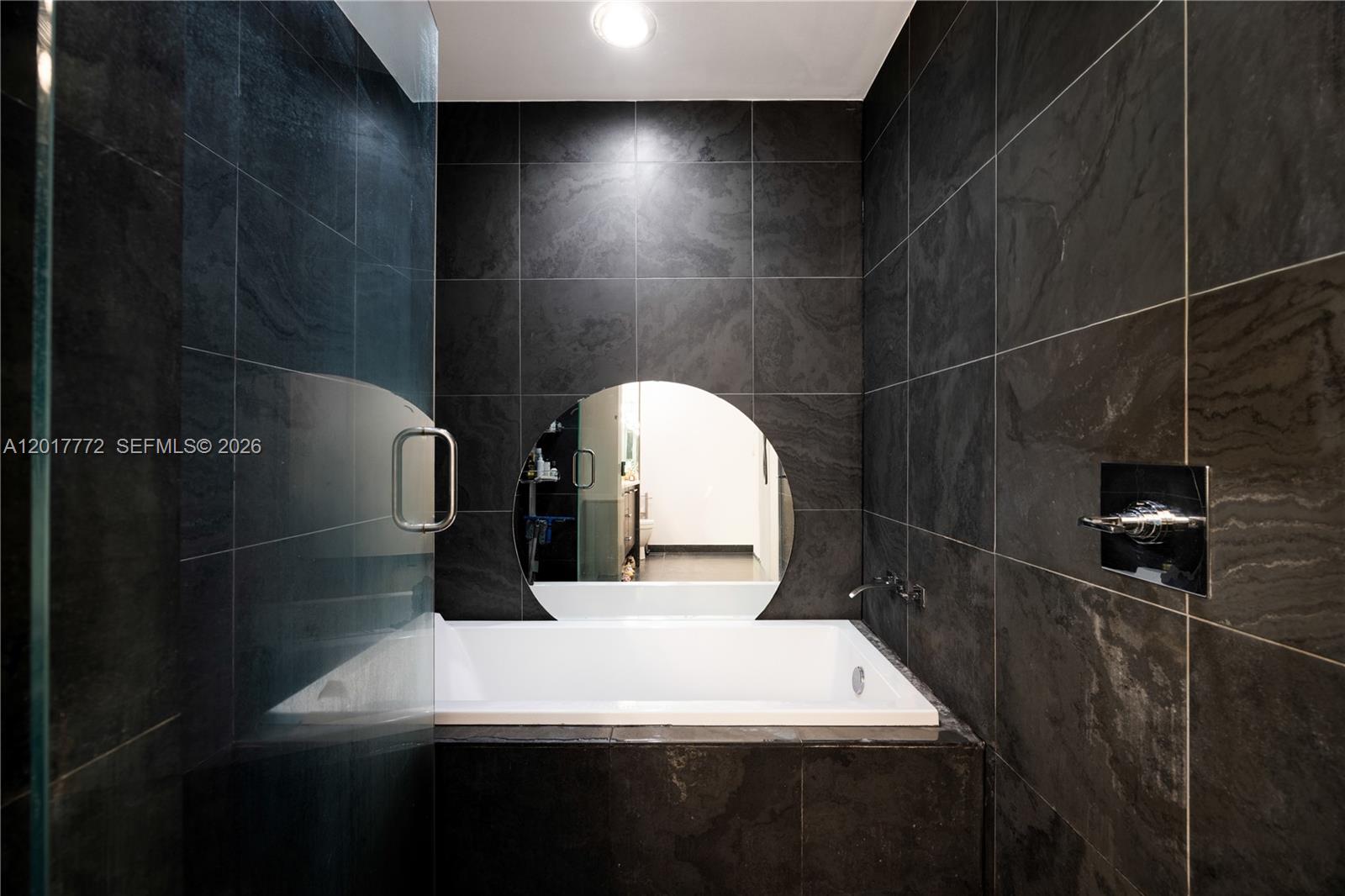 900 Biscayne Boulevard, Unit 4205 Miami, FL 33132 - Photo 8 of 35 a bathroom with a sink a toilet and mirror