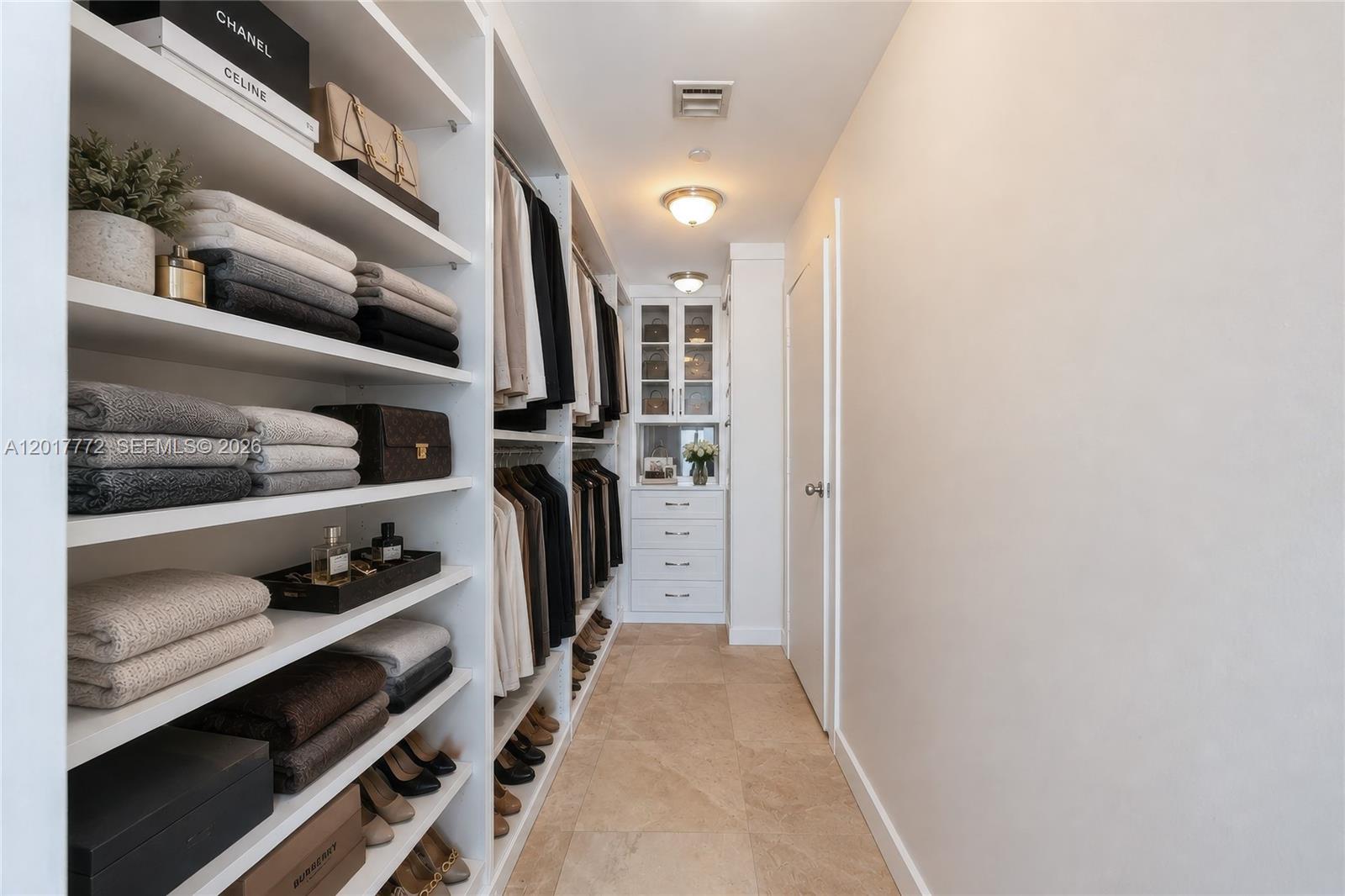 900 Biscayne Boulevard, Unit 4205 Miami, FL 33132 - Photo 9 of 35 a view of walk in closet with clothes and shoes