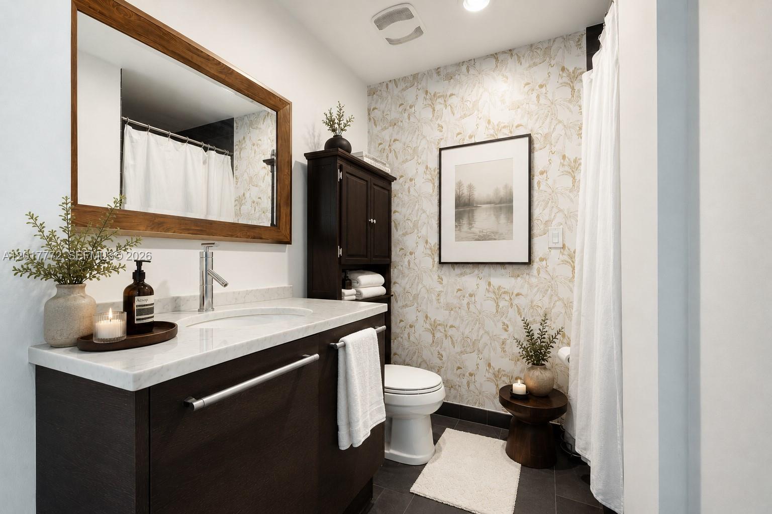 900 Biscayne Boulevard, Unit 4205 Miami, FL 33132 - Photo 10 of 35 a bathroom with a toilet sink and mirror