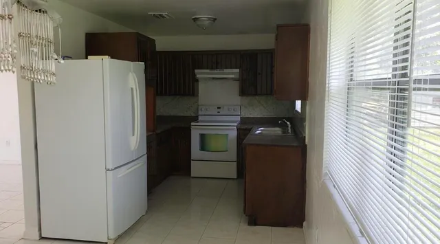 a kitchen with a refrigerator and a stove