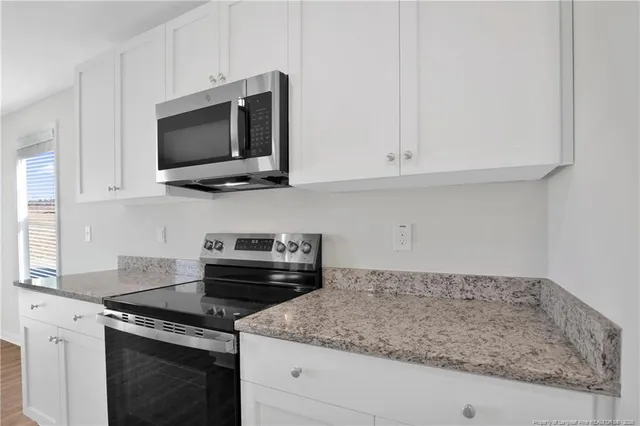 a kitchen with a stove and a microwave