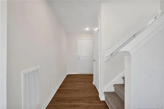 a view of a hallway with the wooden floor