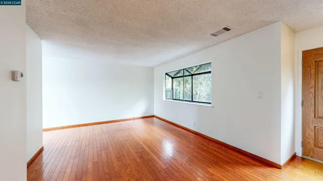 a view of a kitchen with wooden floor and a sink