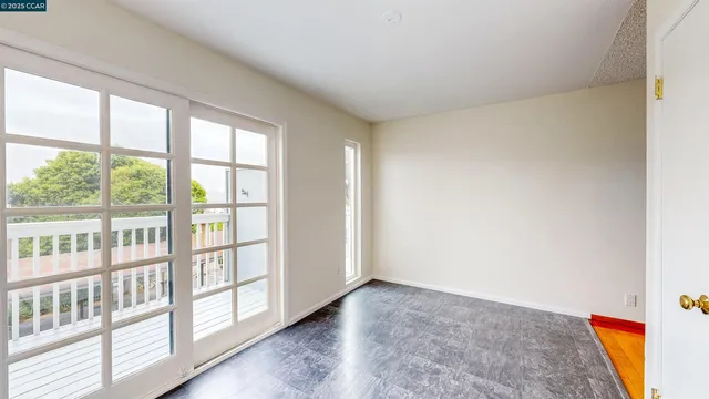 a kitchen with white cabinets and a window