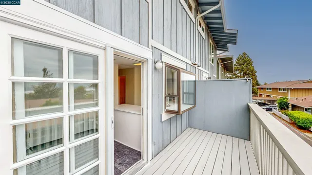 a white toilet sitting next to a white wall