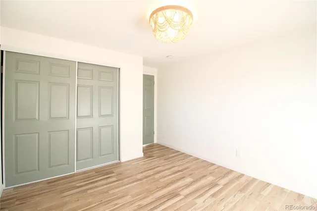 a view of a room with wooden floor