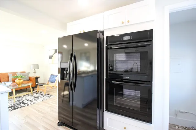 a kitchen with a refrigerator and cabinets