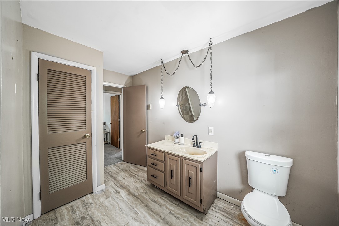 6916 Dewey Road Thompson, OH 44086 - Photo 12 of 49 Half bathroom featuring vanity and light wood finished floors