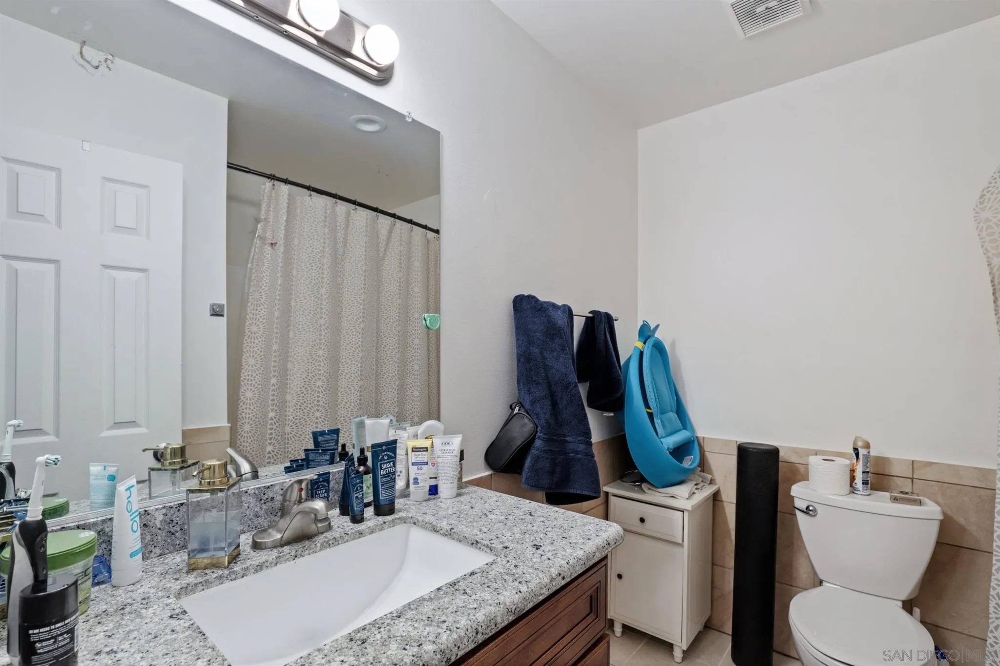 1633 Thomas Avenue San Diego, CA 92109 - Photo 13 of 48 a bathroom with a granite countertop sink and a mirror