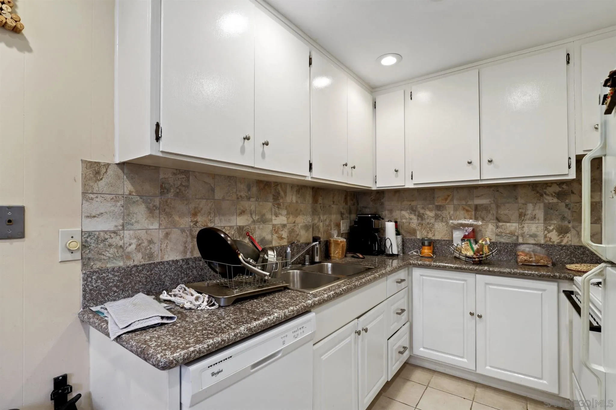 1633 Thomas Avenue San Diego, CA 92109 - Photo 17 of 48 a kitchen with stainless steel appliances granite countertop a sink stove and cabinets