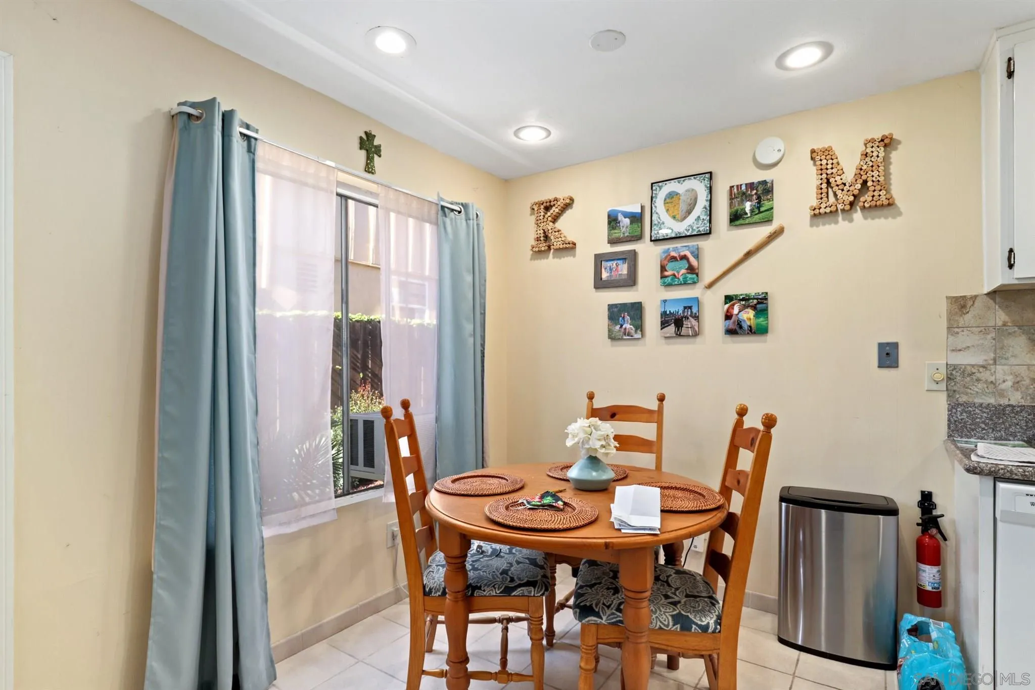 1633 Thomas Avenue San Diego, CA 92109 - Photo 18 of 48 a view of a dining room with furniture and a kitchen
