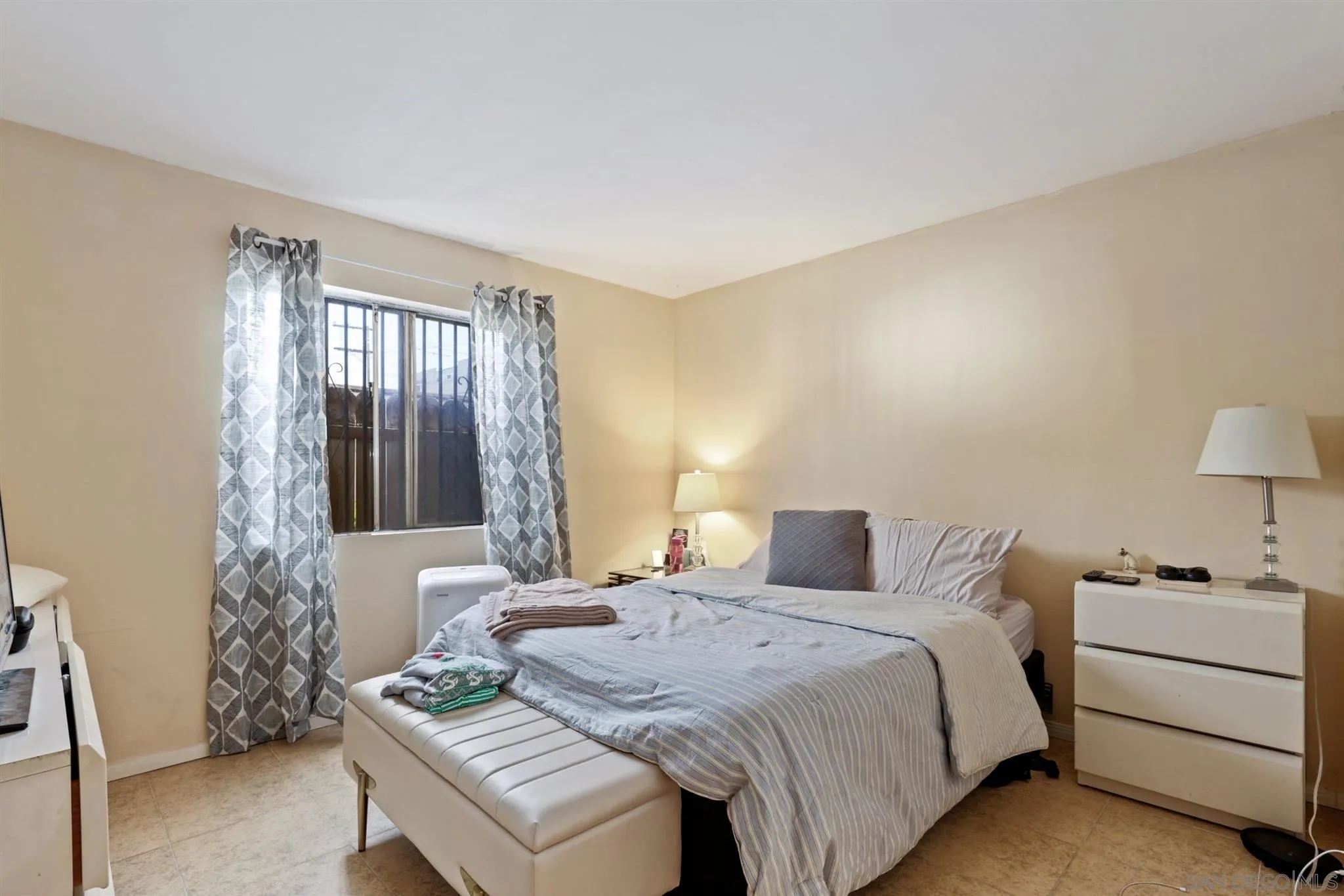 1633 Thomas Avenue San Diego, CA 92109 - Photo 20 of 48 a bedroom with a bed and a dresser