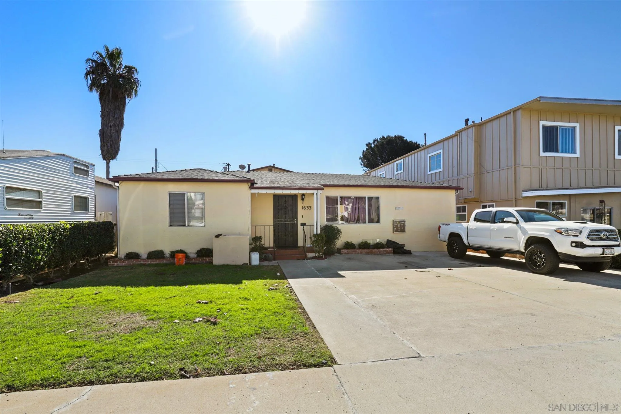 1633 Thomas Avenue San Diego, CA 92109 - Photo 2 of 48 a front view of a house with a garden and yard