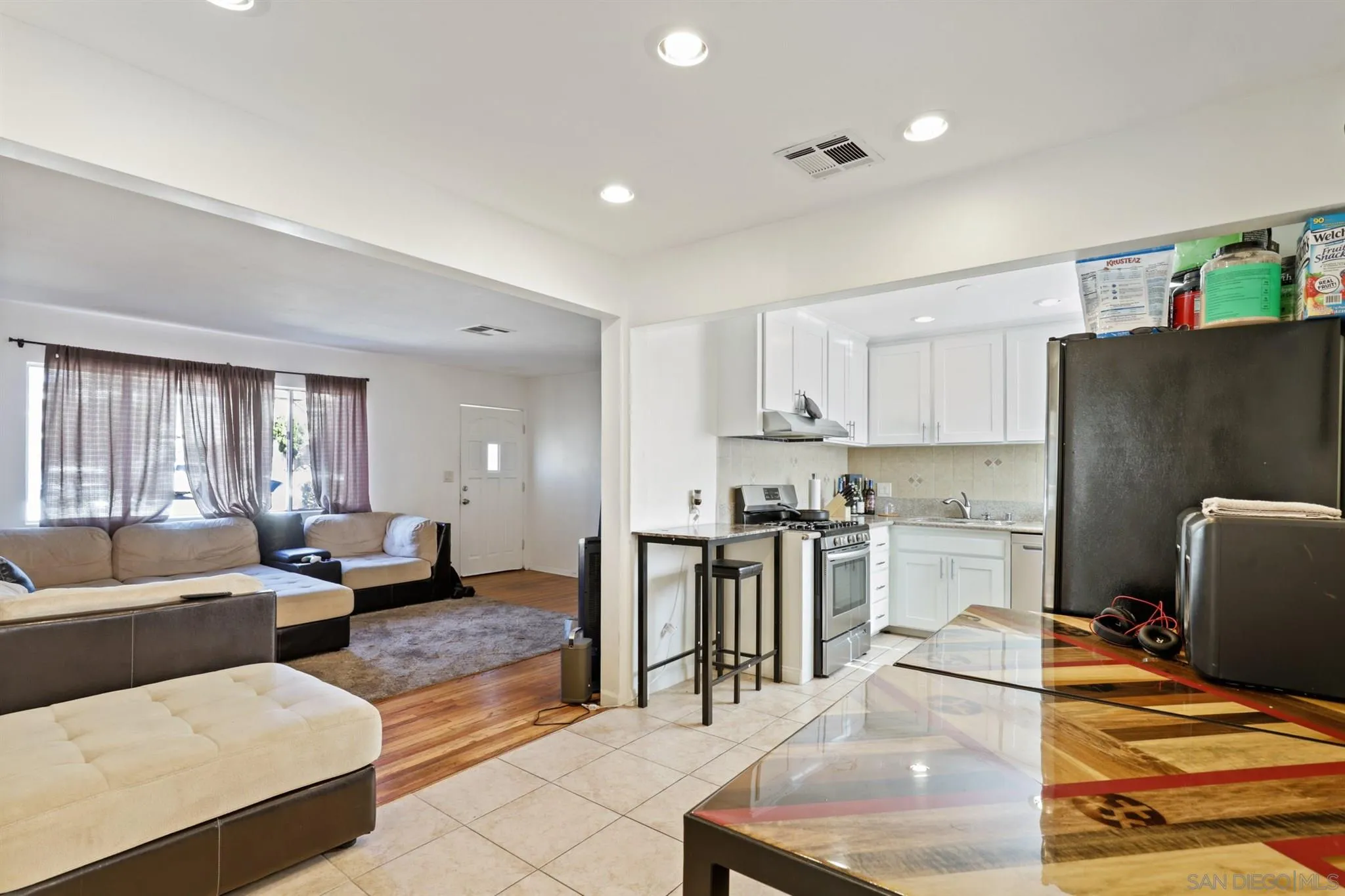 1633 Thomas Avenue San Diego, CA 92109 - Photo 26 of 48 a living room with stainless steel appliances furniture stove and a view of kitchen