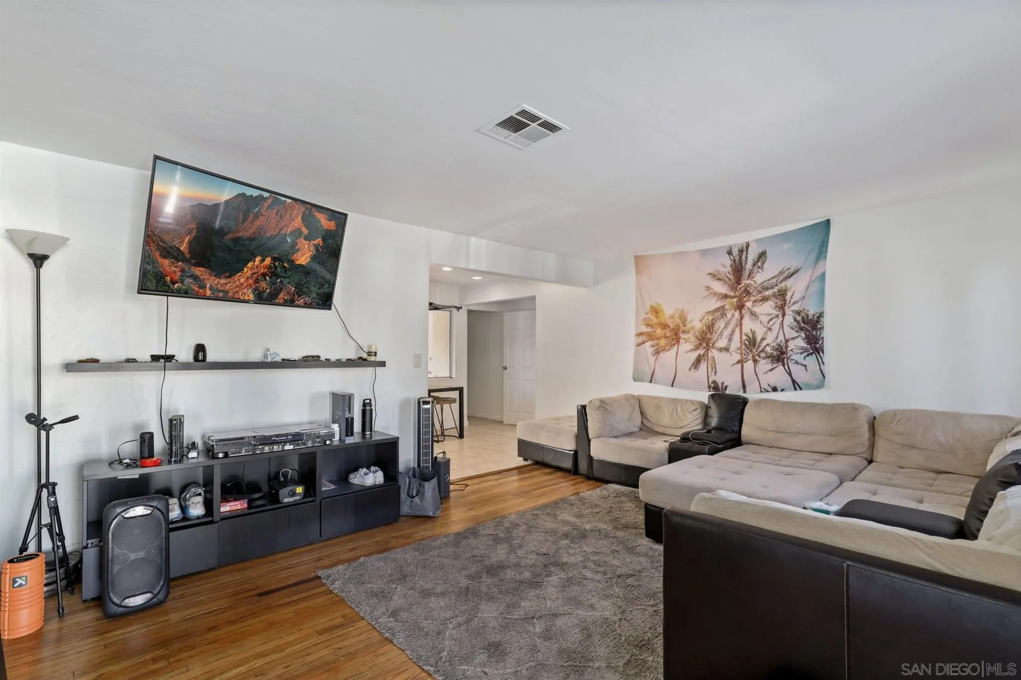 1633 Thomas Avenue San Diego, CA 92109 - Photo 31 of 48 a living room with furniture and wooden floor