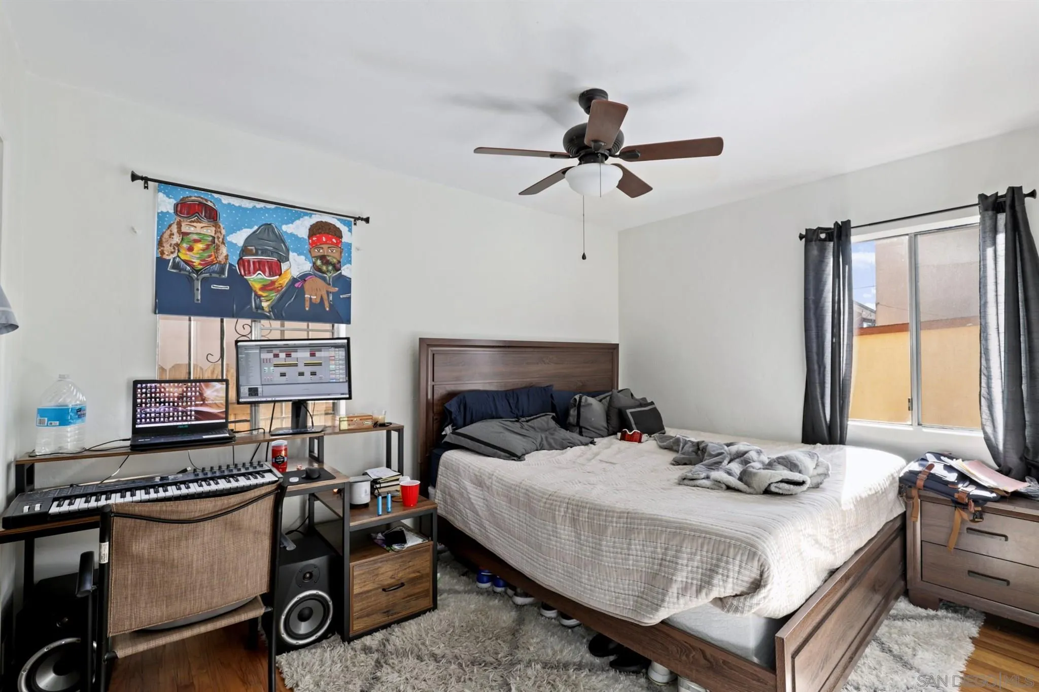 1633 Thomas Avenue San Diego, CA 92109 - Photo 33 of 48 a bedroom with a bed and a chandelier