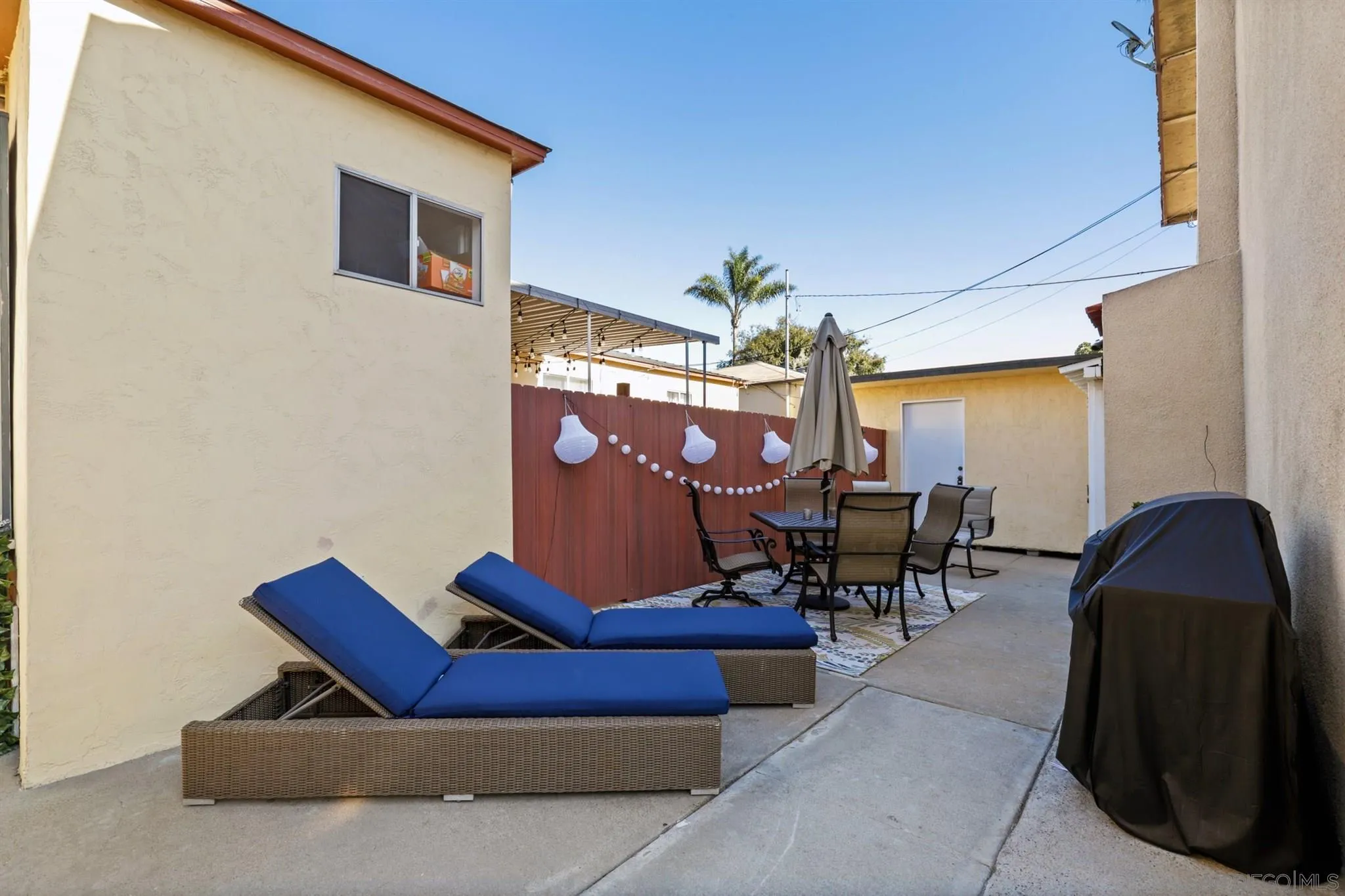 1633 Thomas Avenue San Diego, CA 92109 - Photo 39 of 48 a living room with furniture a dining table and a chandelier