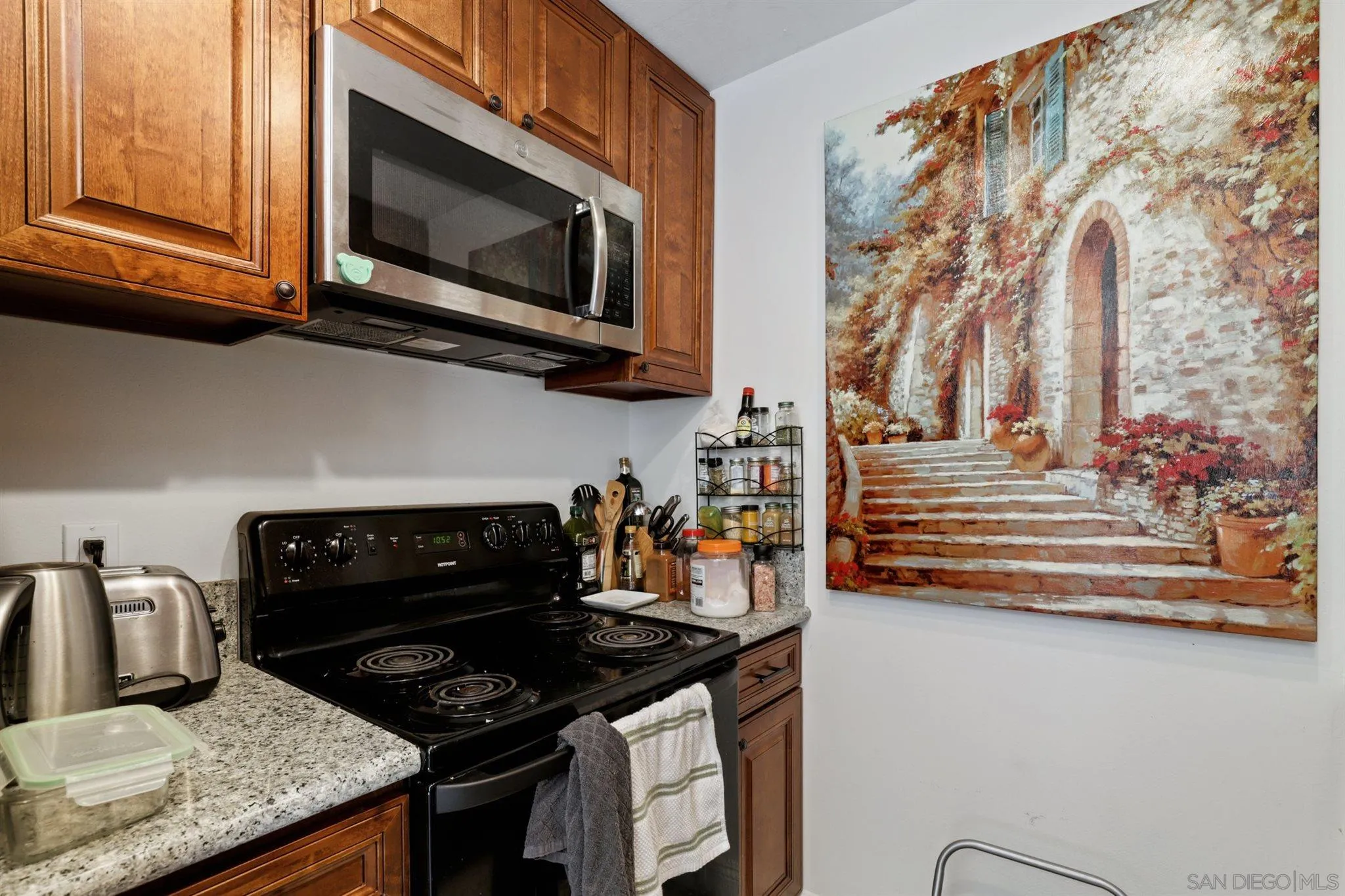 1633 Thomas Avenue San Diego, CA 92109 - Photo 6 of 48 a kitchen with granite countertop stainless steel appliances and cabinets