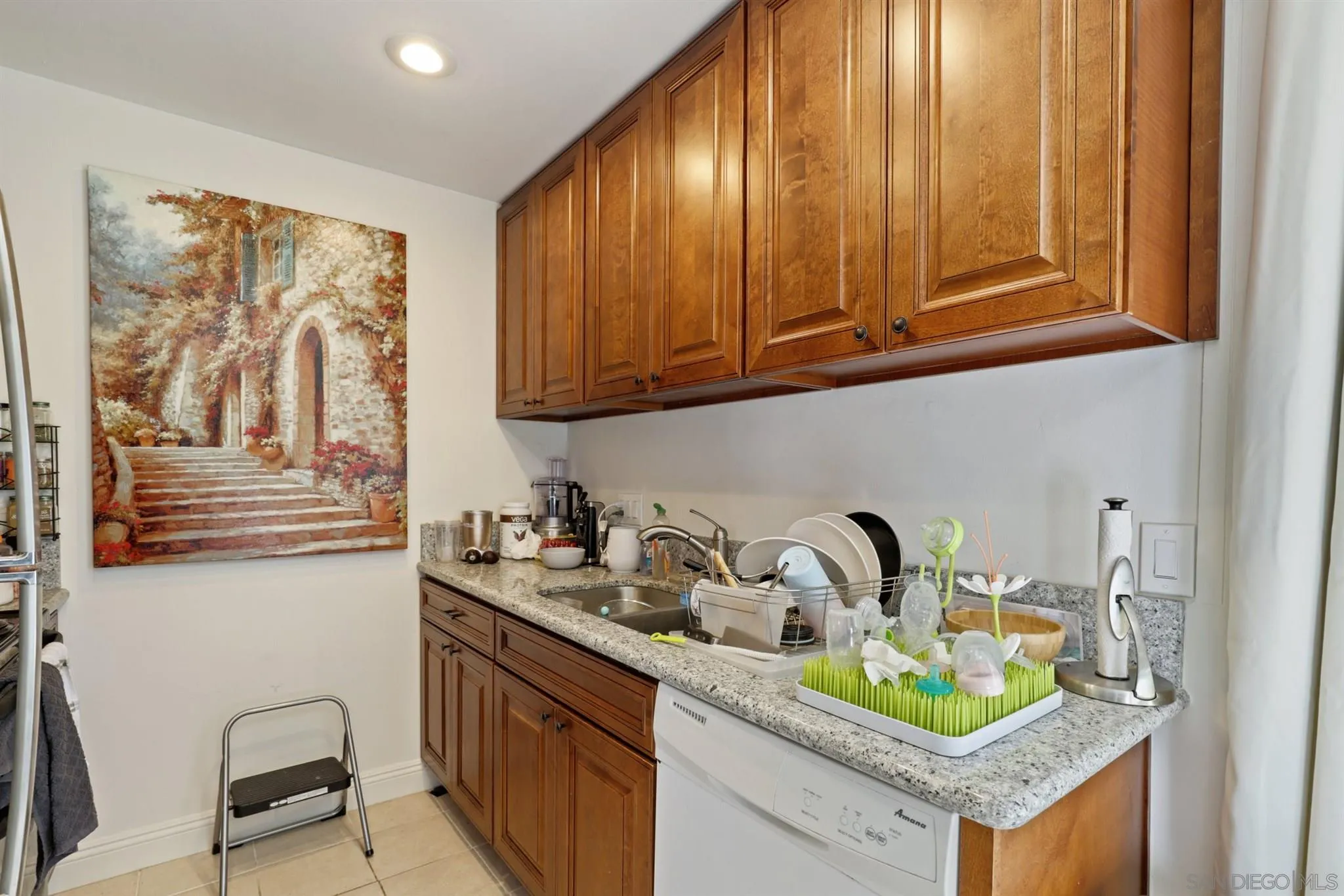 1633 Thomas Avenue San Diego, CA 92109 - Photo 7 of 48 a kitchen with a sink a stove and cabinets