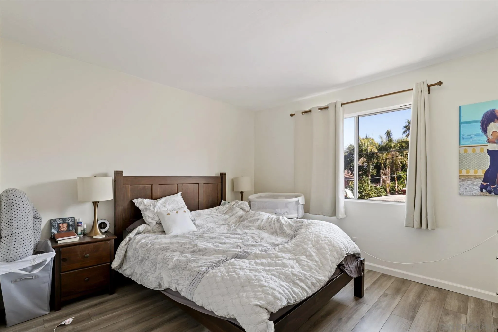 1633 Thomas Avenue San Diego, CA 92109 - Photo 10 of 48 a bed sitting in a bedroom next to a window