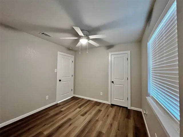 a view of a livingroom with wooden floor and white walls